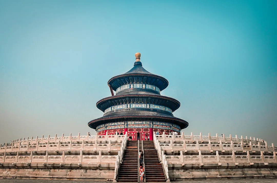 The blue-roofed Hall of Prayer for Good Harvests at the Temple of Heaven in Beijing under a clear sky.