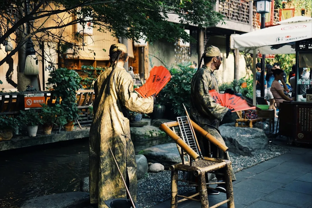Jinli Ancient Street in Chengdu with traditional façades, lanterns, and evening foot traffic.