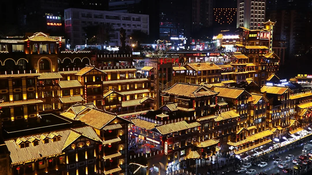 Hongyadong and central Chongqing glowing at night above the river.