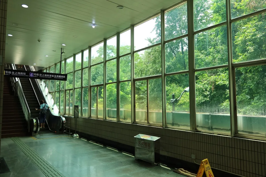 A clean Shanghai Metro platform with English signage and a train arriving.