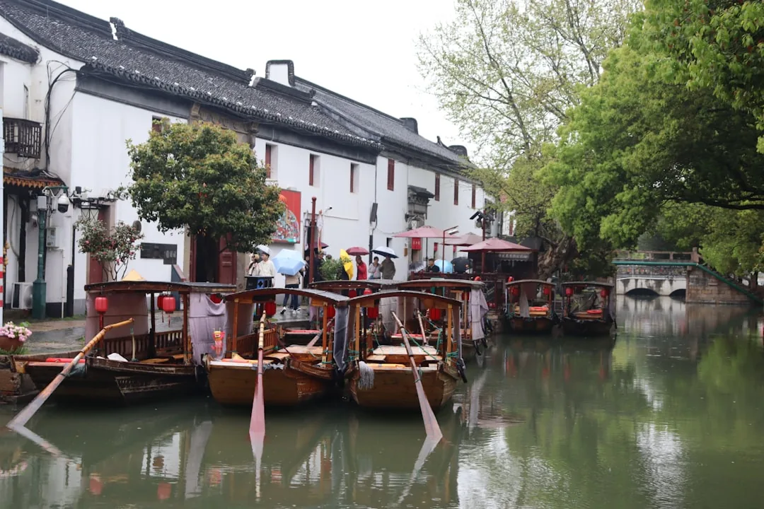A water-town canal scene in Zhujiajiao near Shanghai with stone bridges and narrow lanes.