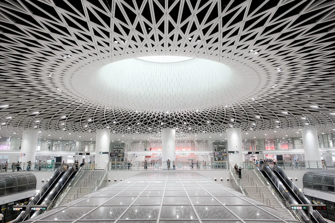 A modern Shenzhen metro station interior with a patterned ceiling.