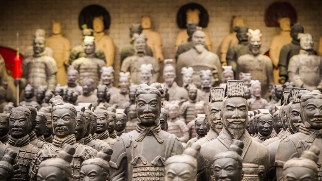 Rows of Terracotta Army warrior statues in Xi'an, each with distinct faces and armor.
